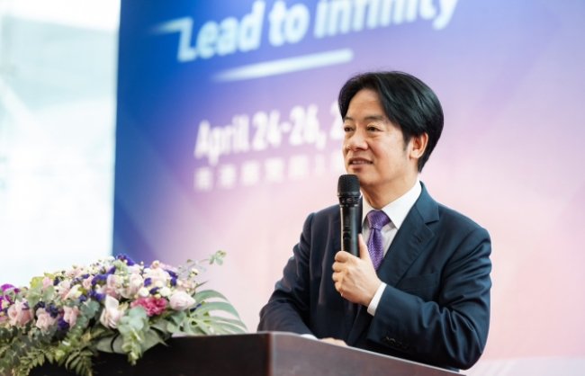 Vice President Lai Ching-te speaking at a podium at an event.